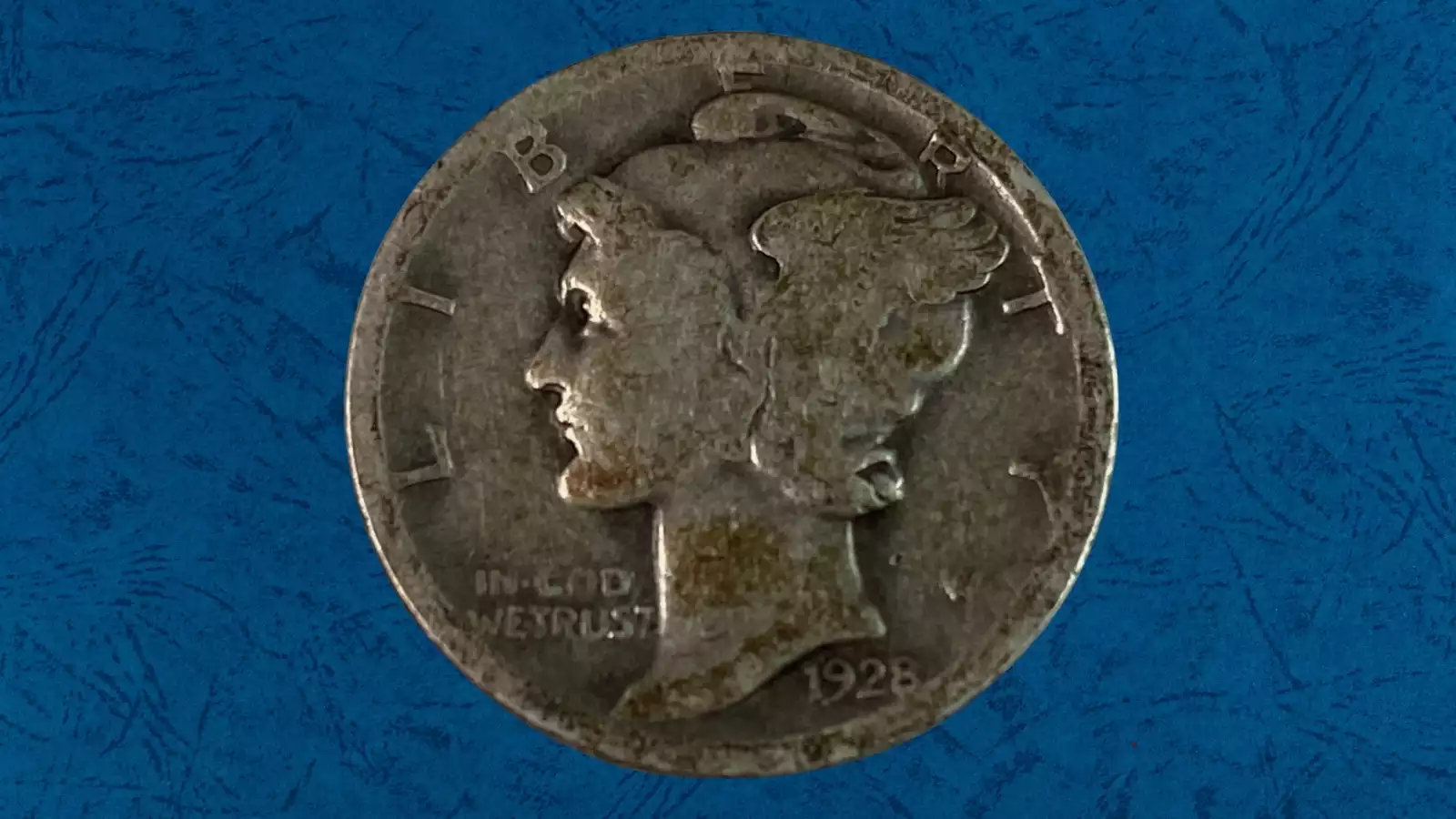1928 Mercury dime lamination error showing peeling surface metal and internal planchet separation on coin surface